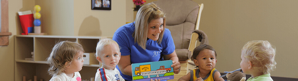 Kids being showed a book during reading time