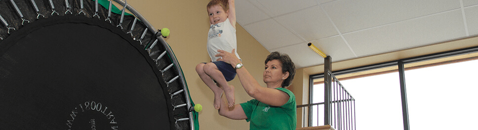 Kid practicing on zipline during therapy.